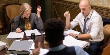 Three interracial co-workers looking through juridical documents