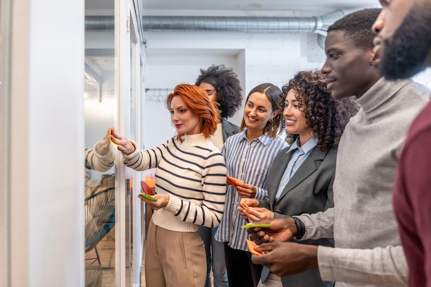 A group of diverse people attending a job fair, looking at booths and talking with recruiters. The scene is brightly lit, conveying a sense of hope and opportunity.