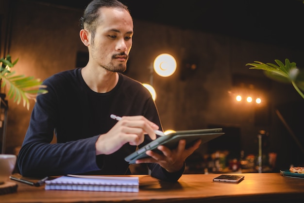 A person using a tablet to research and plan, symbolizing preparation. The person is in a bright, modern setting.